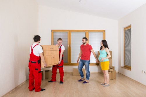 Removal team loading furniture into a van in Leyton
